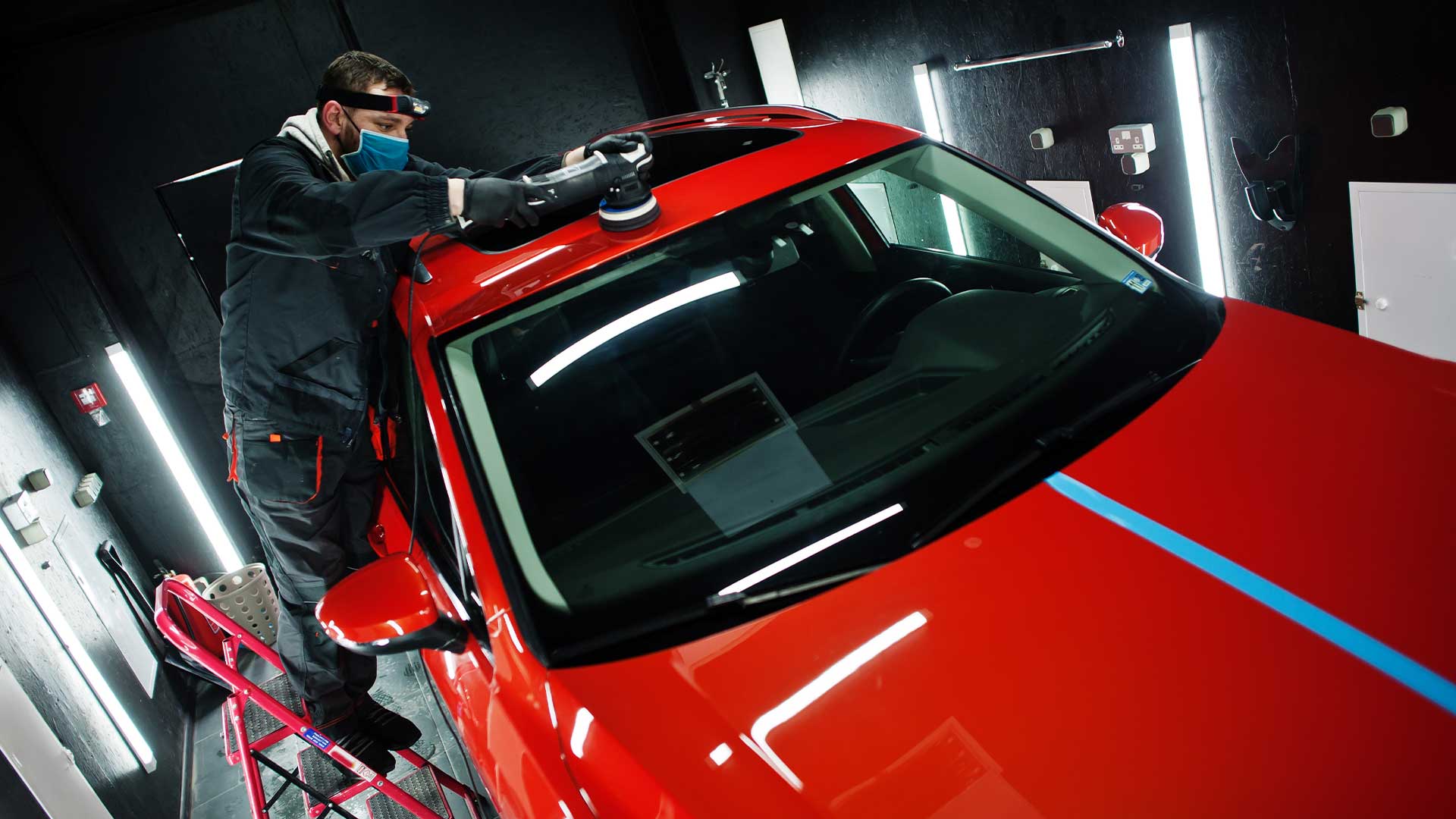 Certified installer applying protection tape before vehicle wrap in Buena Park