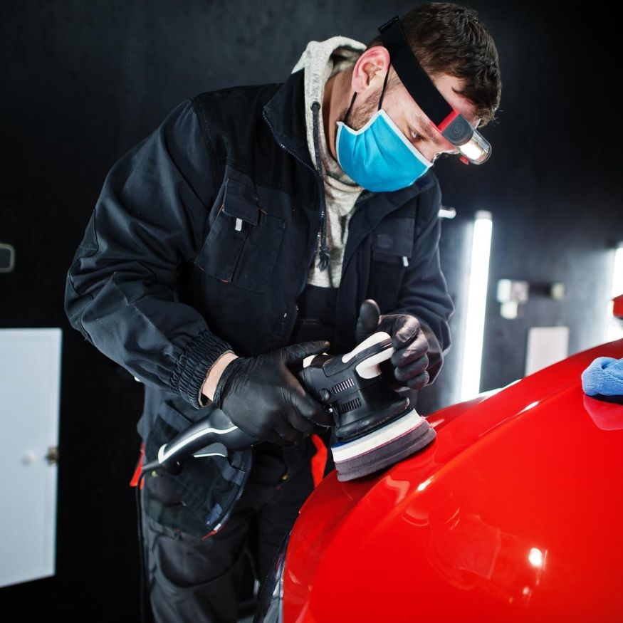 Certified installer applying protection tape before vehicle wrap in Buena Park